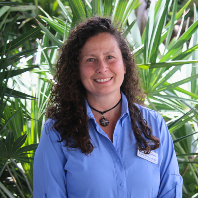 woman with dark curly hair smiling