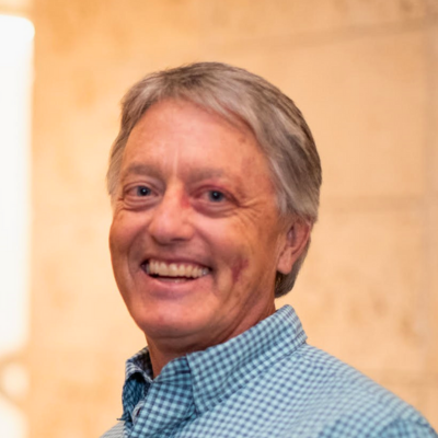 man with salt and pepper hair smiling