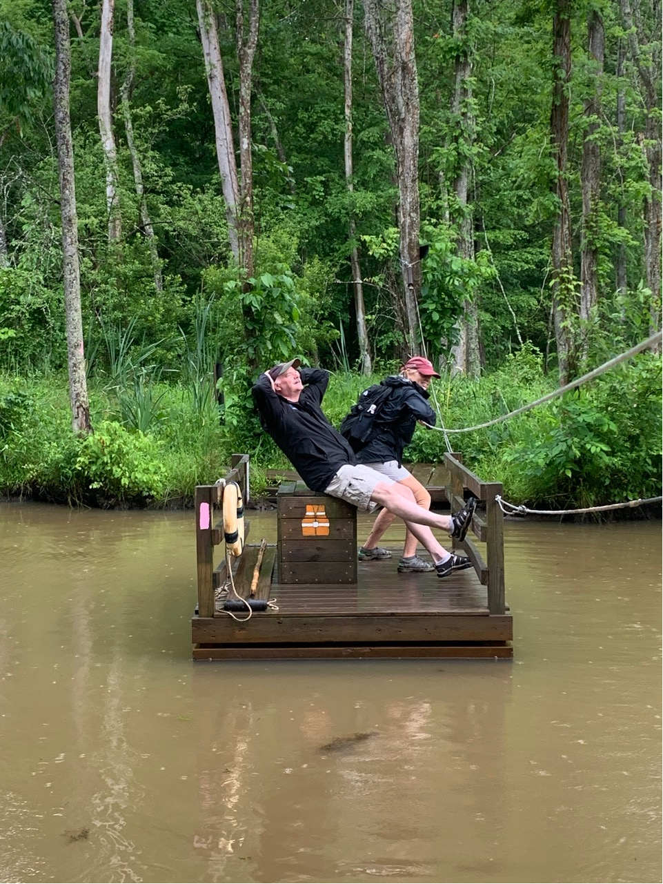 man and woman sitting on floating dock