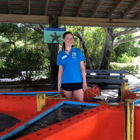 young girl at touch tank smiling