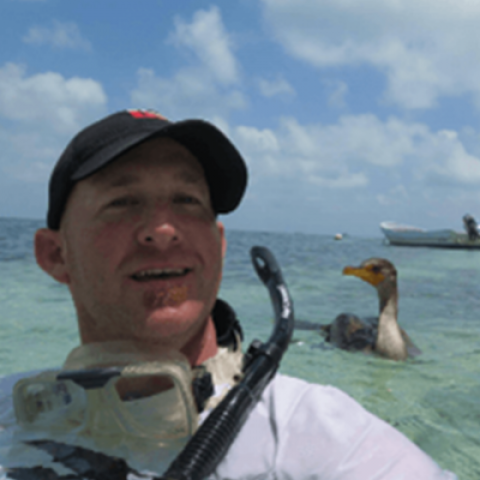 selfie of man in water with water bird in backgroun